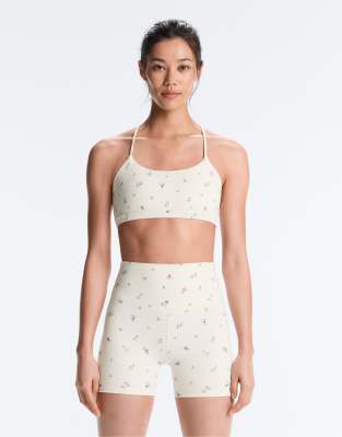 OYSHO Evermove light support floral print sports bra in pale ecru-Neutral