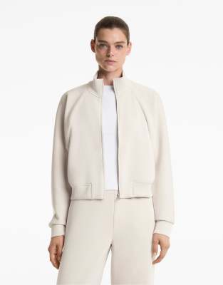 OYSHO - Gestreifte Jacke in Hellrosa aus weichem Modal mit hohem Kragen