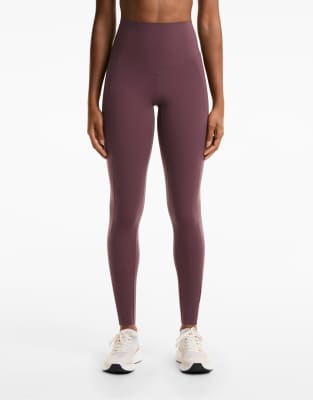 OYSHO - Knöchellange Kompressions-Leggings in Burgunderrot mit Tasche und hohem Bund, 65 cm Schrittlänge