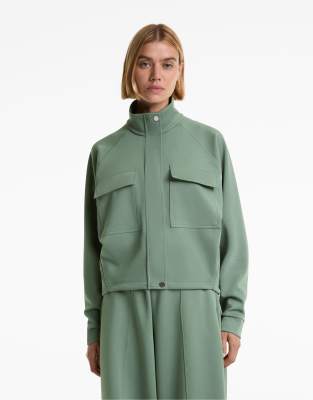 OYSHO - Pikee-Jacke in verwaschenem Grün mit Baumwollanteil und Taschen