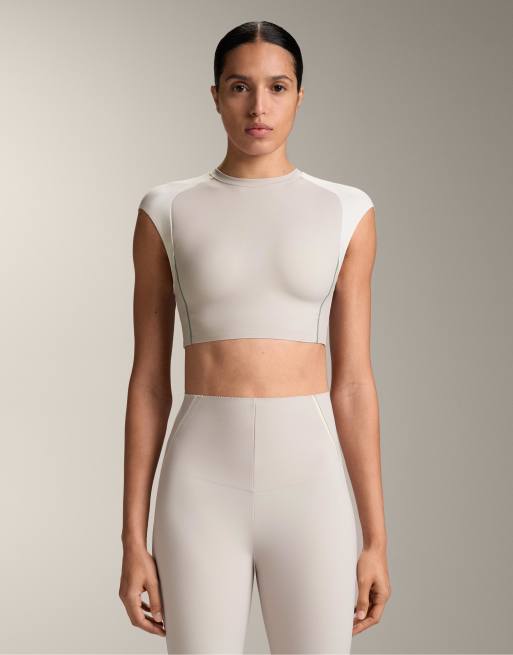 OYSHO - Top senza maniche a compressione riflettente color tortora