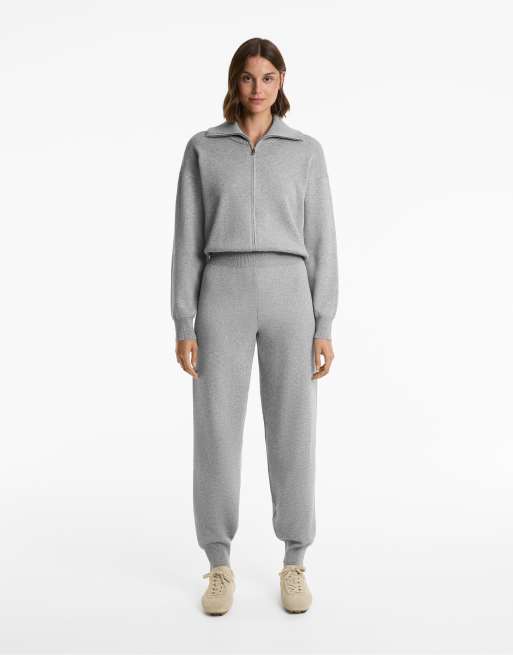 OYSHO - Tuta jumpsuit a taglio lungo con zip corta nera
