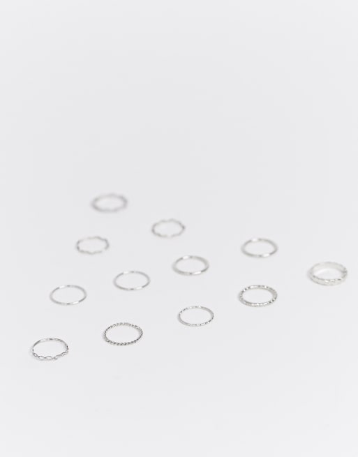 Pack de 12 anillos con mezcla de texturas y diseños retorcidos en plateado de ASOS DESIGN