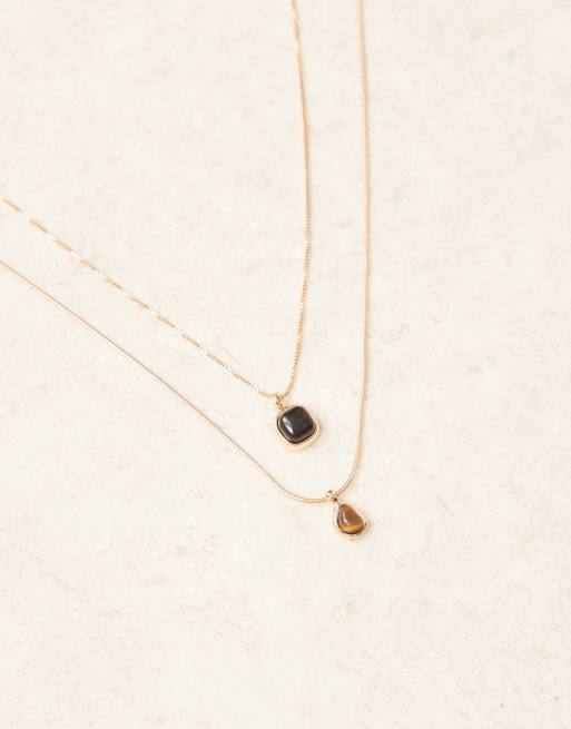 Pack de 2 collares dorados con colgantes de ónice y ojo de tigre de ASOS DESIGN  , 2 de 3