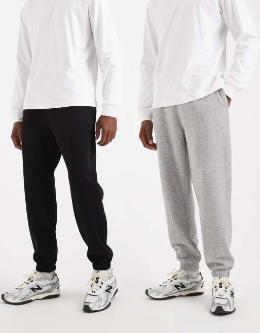 Pack de 2 joggers básicos de color negro y gris jaspeado de corte tapered de ASOS DESIGN