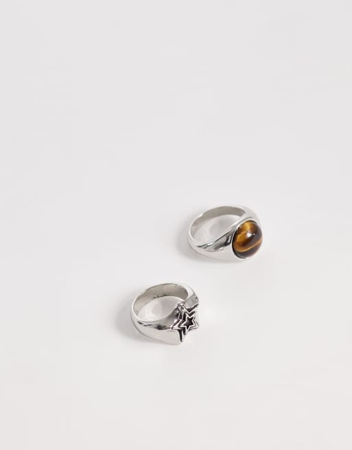 Pack de 2 anillos tipo sello plateados con diseño de estrella y detalle de ojo de tigre de ASOS DESIGN