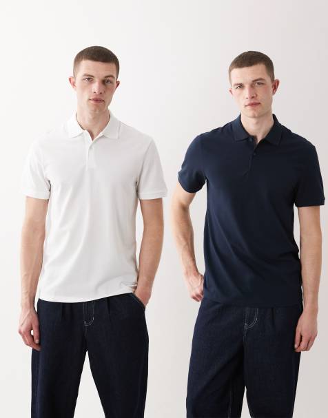 Pack de 2 polos de color azul marino y blanco básicos de corte estándar de piqué Essentials de ASOS DESIGN - view 1