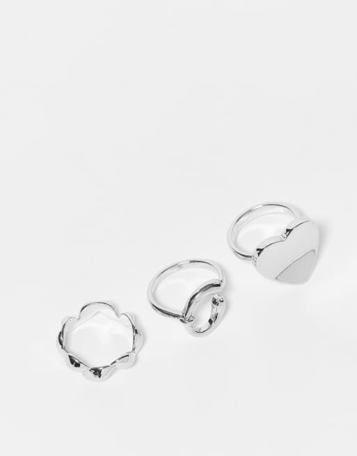 Pack de 3 anillos plateados con diseños de herradura y corazones de SVNX