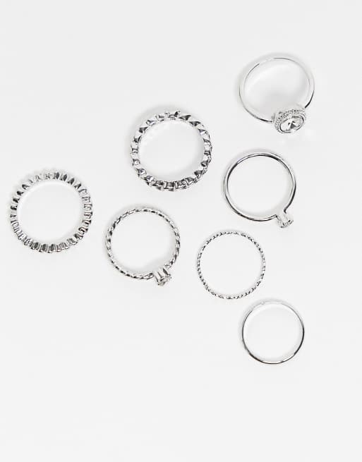 Pack de 7 anillos plateados con diseños variados de cristal de ASOS DESIGN