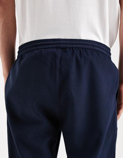 Pantalones azul marino de corte tapered de ASOS DESIGN (parte de un conjunto), 4 de 5