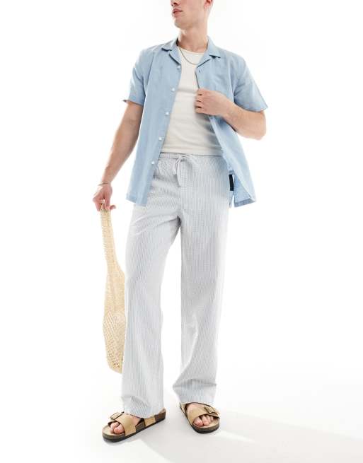 Pantalones azules y blancos a rayas de corte ancho con cintura elástica de sirsaca de ASOS DESIGN
