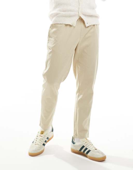 Pantalones beis de corte tapered de mezcla de lino de Another Influence