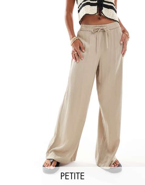 Pantalones beis plisados de pernera ancha con caída de tejido satinado de Vila Petite - view 1