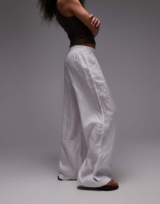 Pantalones blancos de corte palazzo con cinturilla sin cierres de lino puro de ARKET, 2 de 5
