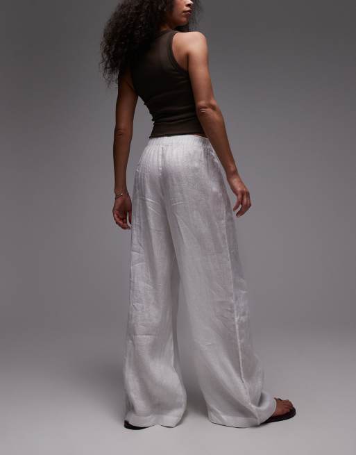 Pantalones blancos de corte palazzo con cinturilla sin cierres de lino puro de ARKET, 4 de 5