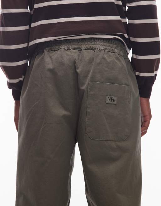 Pantalones caquis sin cierres con logo pequeño de tejido antidesgarros de algodón de No Problemo, 5 de 5
