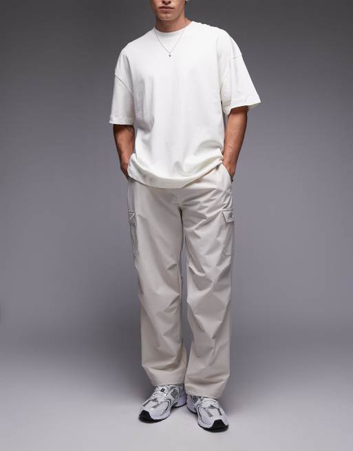 Pantalones cargo blanco hueso de tejido antidesgarros de New Balance, 2 de 5