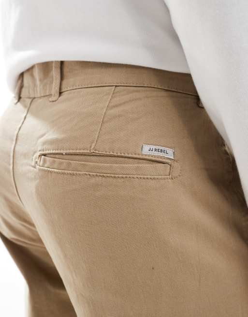 Pantalones chinos beis de corte suelto de JJ Rebel, 5 de 5