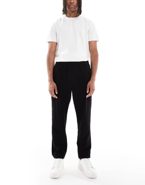 Pantalones chinos negros de corte tapered sin cierres de ASOS DESIGN - view 1