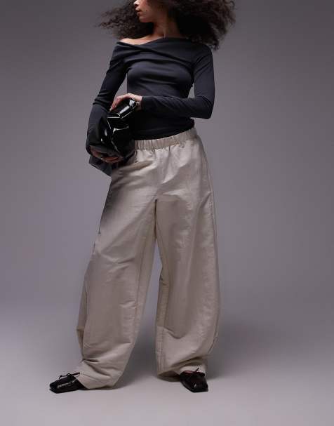 Pantalones color crema con cintura elástica y tacto satinado de Mango - view 1