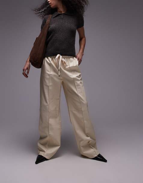 Pantalones color crema con costura delantera de cuero suave de Mango - view 1