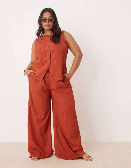 Pantalones color óxido de corte palazzo de tejido efecto rugoso de ASOS DESIGN Curve (parte de un conjunto)