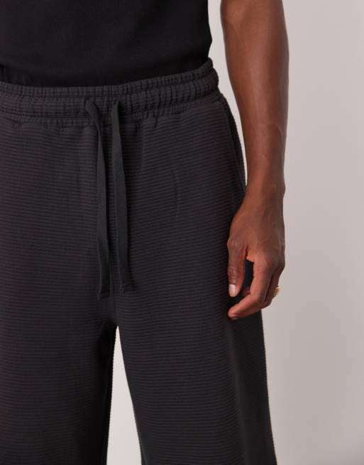 Pantalones cortos azul marino de corte alargado de tejido texturizado de ASOS DESIGN, 4 de 5