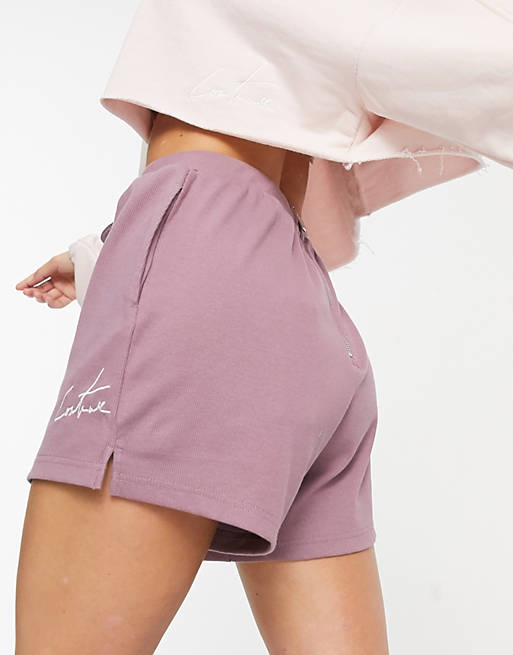 Pantalones cortos de correr en color uva con logo de The Couture Club