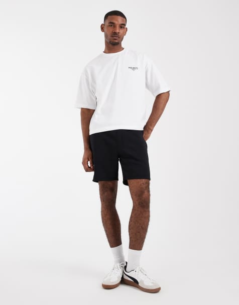 Pantalones cortos negros básicos de largo medio y corte slim de punto liso Essentials de ASOS DESIGN - view 1