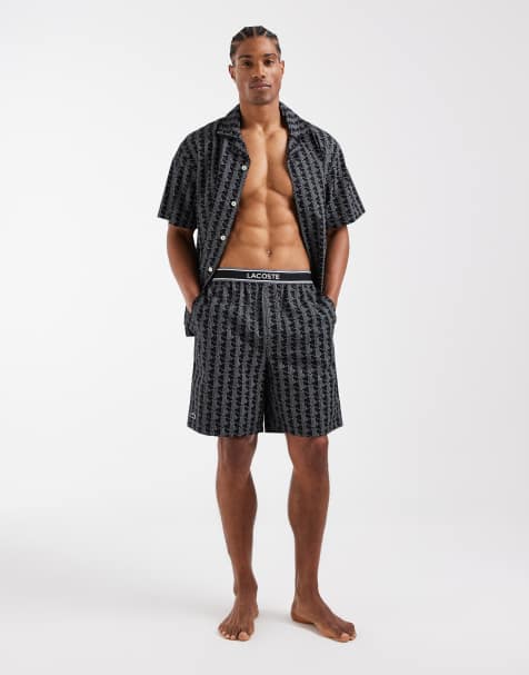 Pantalones cortos negros con estampado de monograma y logo en la cinturilla de Lacoste - view 1