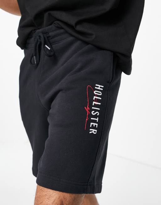 Pantalones cortos negros técnicos modernos con logo de tejido de chándal de Hollister