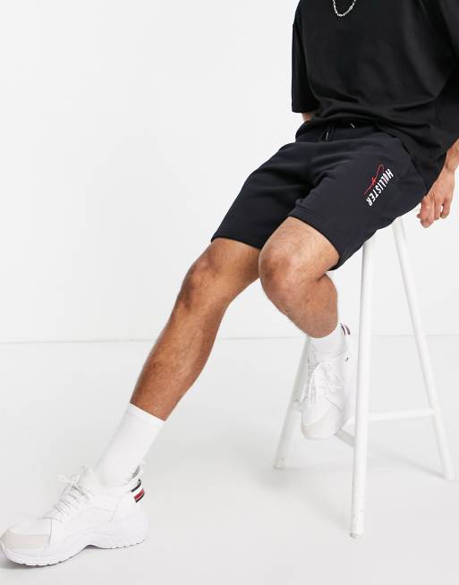 Pantalones cortos negros técnicos modernos con logo de tejido de chándal de Hollister