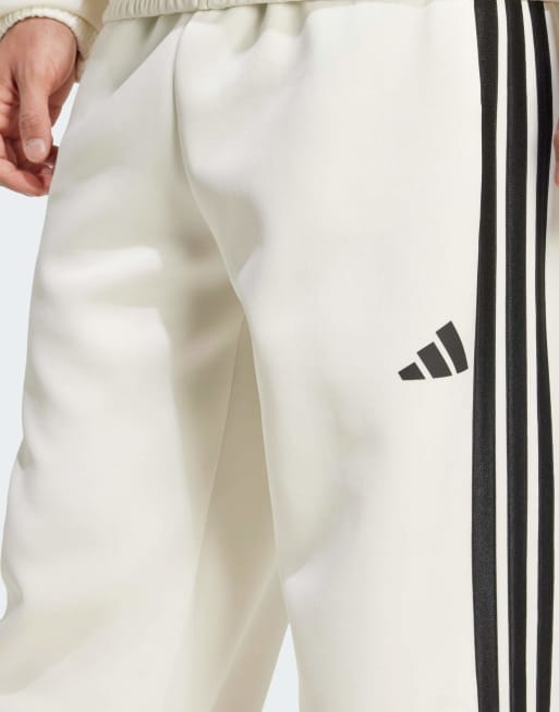 Pantalones de chándal blanco hueso y negros Stadium de adidas Performance, 3 de 5