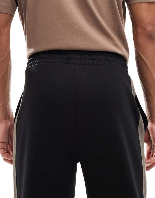 Pantalones de chándal negros holgados con logo Dolos de HUGO RED, 4 de 5