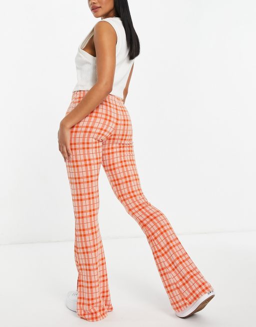 Pantalones naranjas acampanados de pernera ancha y corte holgado de ASOS  DESIGN