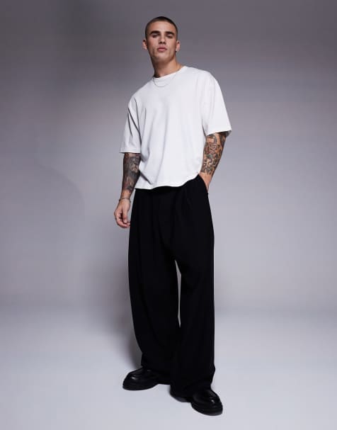 Pantalones de vestir negros de corte herradura con cinturón de ASOS DESIGN - view 1