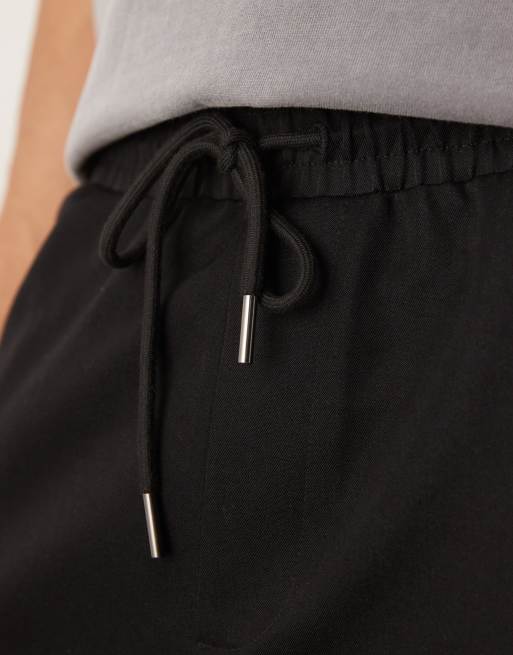 Pantalones de vestir negros de corte tapered sin cierres de ASOS DESIGN, 4 de 5