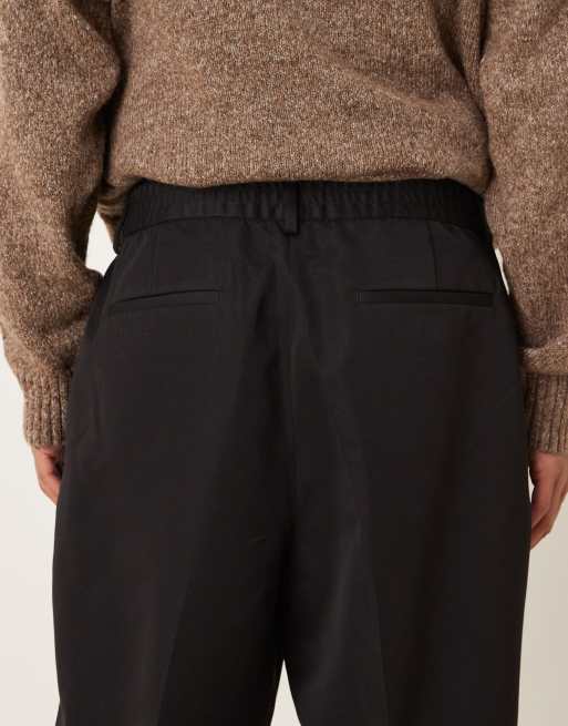 Pantalones de vestir negros de pernera ancha con pinzas media cinturilla elástica de ASOS DESIGN, 4 de 5