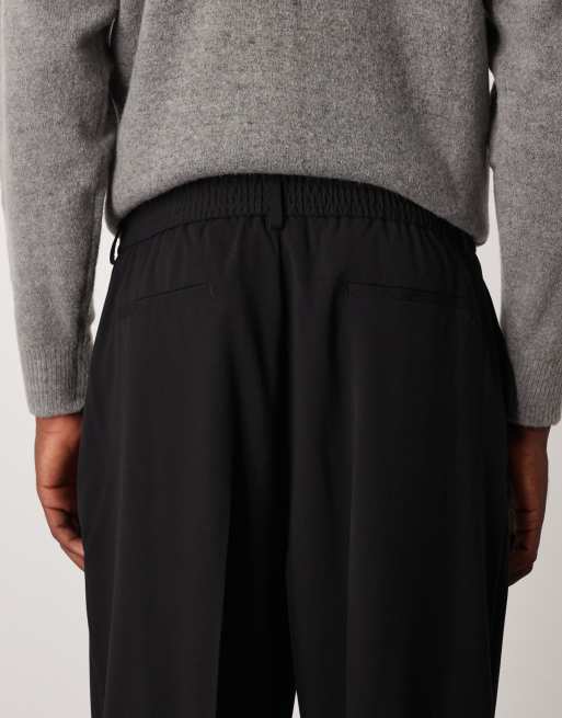 Pantalones de vestir negros sin cierres de corte tapered extragrande de ASOS DESIGN, 4 de 5