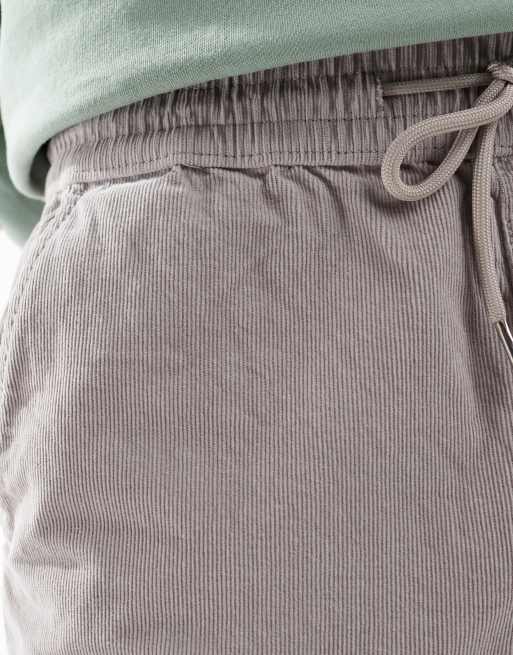 Pantalones grises de corte tapered con cinturilla elástica de pana de ASOS DESIGN, 4 de 5