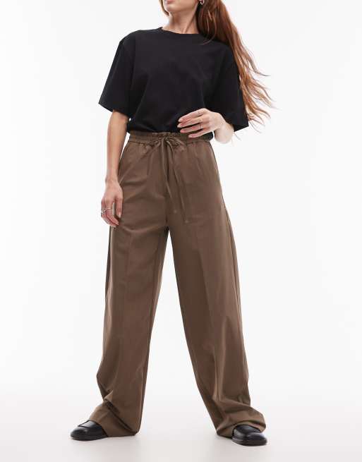 Pantalones marrones holgados con cinturilla elástica con lazada de Mango