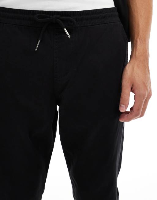 Pantalones negros de corte tapered sin cierres con cinturilla elástica de ASOS DESIGN , 4 de 5