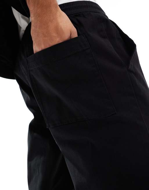 Pantalones negros de corte tapered sin cierres con cinturilla elástica de ASOS DESIGN , 5 de 5