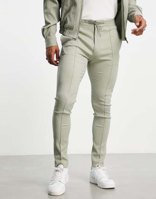 Pantalones pitillo de vestir verde salvia con cinturilla elástica y acabado arrugado de ASOS DESIGN