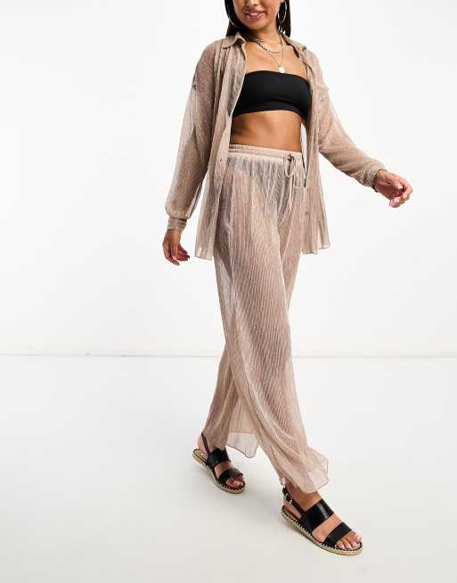Pantalones playeros rosados plisados con acabado metalizado de South Beach 