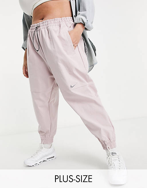 Pantalones rosas claras con logo de Nike Plus