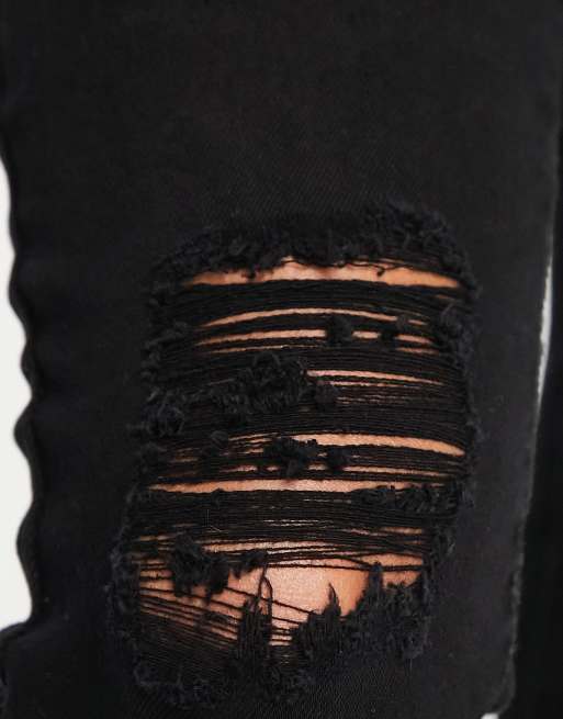 Parisian skinny jeans with ripped knee in black