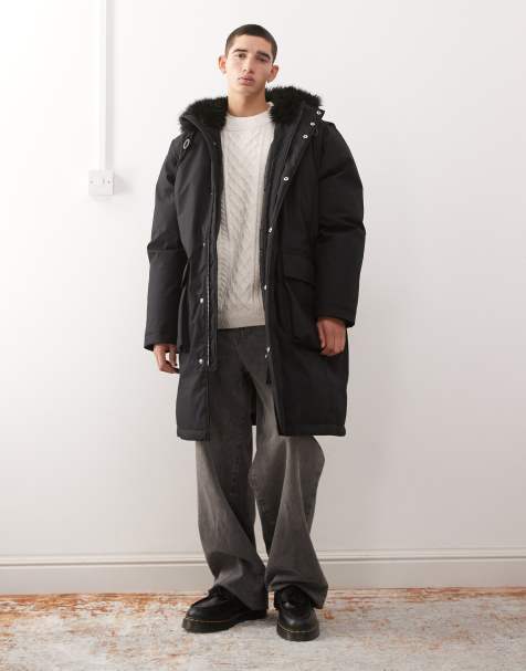 Parka negra extragrande con capucha de piel sintética de Weekday - view 1