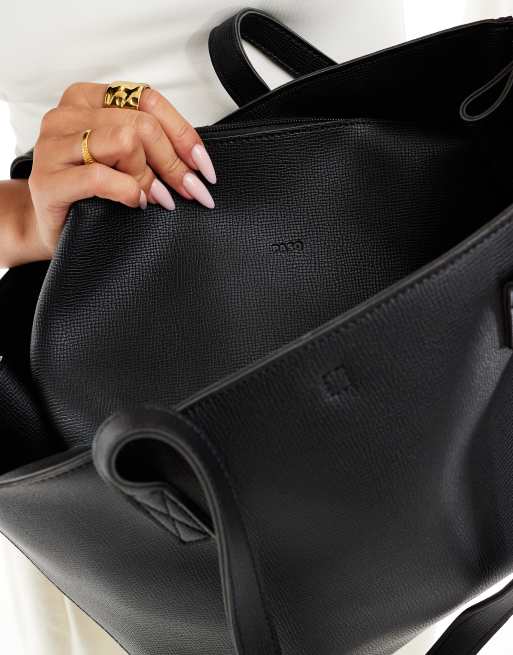 PASQ – Tragetasche in Schwarz mit zwei Henkeln, seitlichen Clip-Details und Struktur, 3 von 4