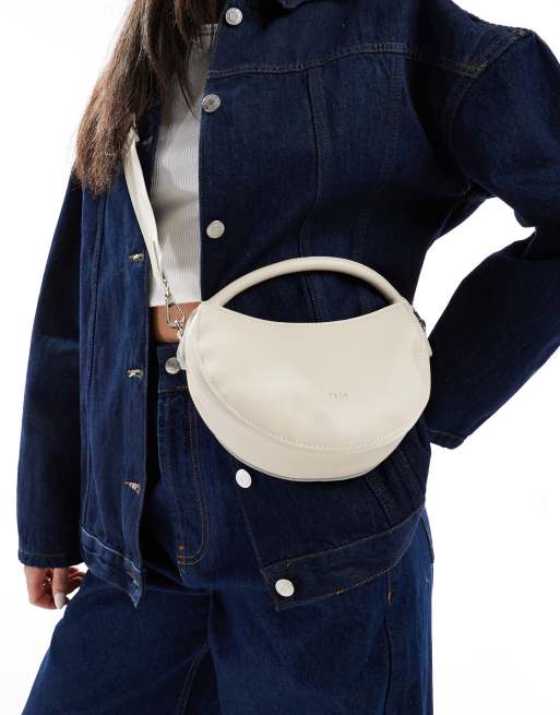 PASQ – Zaokrąglona torebka do ręki w kolorze złamanej bieli z paskiem crossbody